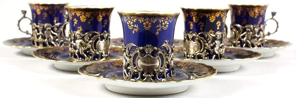 A SET OF FIVE ROYAL VIENNA BLUE AND GILT CUPS AND SIX: A SET OF FIVE ROYAL VIENNA BLUE AND GILT CUPS AND SIX SAUCERS with silver handles