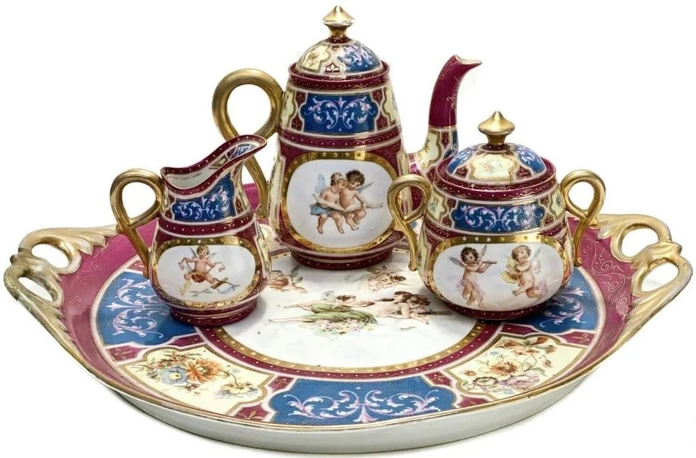 Antique Circa 1920 Royal Vienna Austria Partial Tea Service Set: Antique Circa 1920 Royal Vienna Austria Partial Tea Service Set Royal Vienna Austria tea service. A red, white, and blue wine ground with hand-painted cherubs to the central areas and gilt to the hand