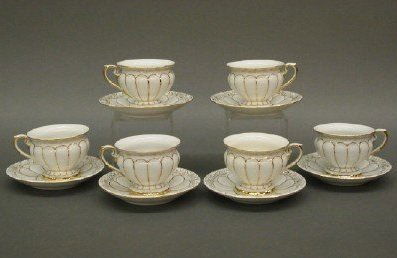 SET OF 6 MEISSEN TEA CUPS AND SAUCERS: Six late 19th century Meissen porcelain teacups and saucers. Molded bodies with paneled design and Fine Gilded detail. Blue underglaze and incised marks. Minor wear. Up to 2 1/2" high. NO INTERNATIONA