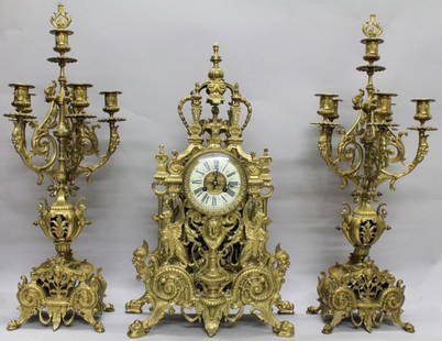 TIFFANY LOUIS XIV STYLE BRONZE CLOCK GARNITURE: TIFFANY & CO. LOUIS XIV STYLE GILT BRONZE CLOCK GARNITURE SET: A fantastic clock garniture set by Tiffany & Co. to include gilt bronze mantle clock with applied decoration to include urn, griffon, Bac