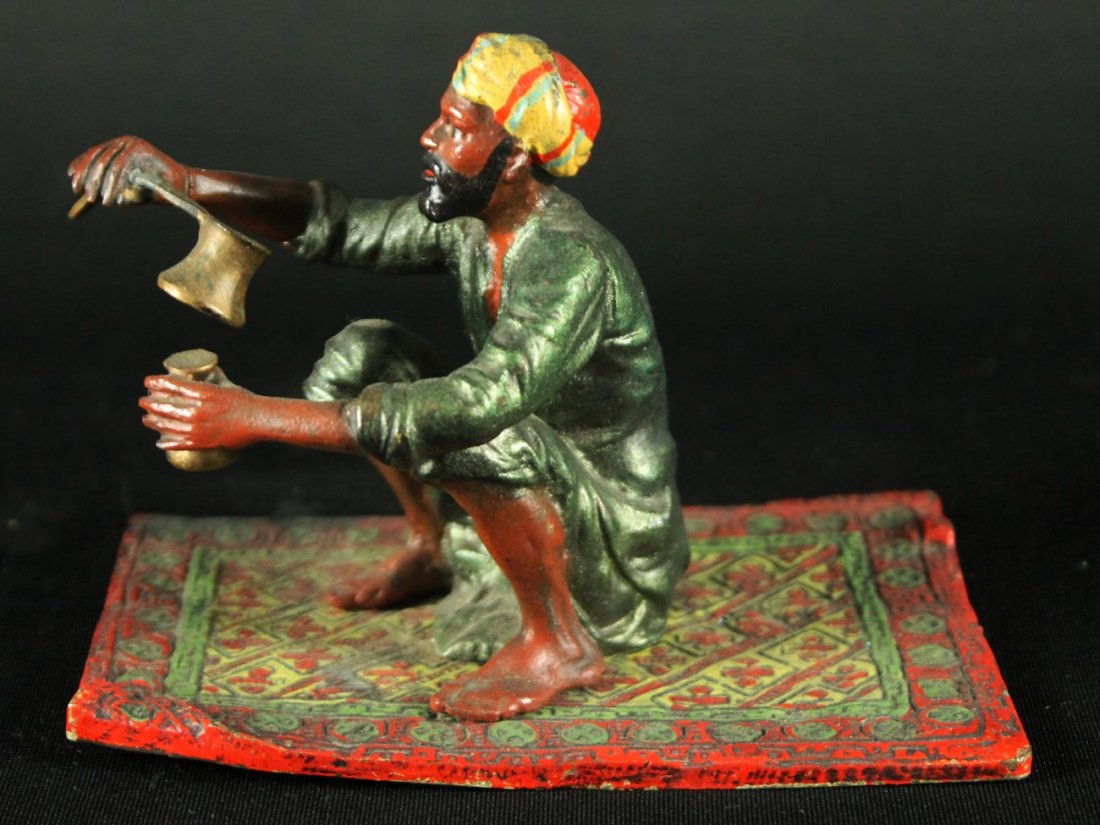 ANTIQUES VIENEES ENAMEL AUSTRIAN COLD PAINTED BRONZE: MAGNIFICENT ANTIQUES MINIATURE FRANZ BERGMAN STYLE VIENNESE ENAMEL VIENNA AUSTRIAN COLD PAINTED BRONZE HAND PAINTED MUSLIM ARAB MAN ON PERSIAN RUG. MEASURES H: 3 1/2" W: 4 3/4" SHIPPING AND HANDLING T