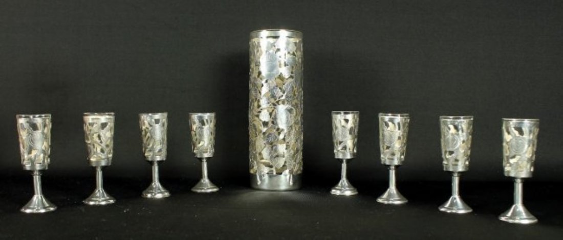STERLING AND GLASS SHOTS: STERLING AND GLASS SHOTS. MEASURES H: 7 1/2" W: 2 1/2" THE SHOTS MEASURE H: 3 3/4" W: 1" SHIPPING AND HANDLING TO 48 STATES OF UNITED STATES: $60 INTERNATIONAL, ALASKA, HAWAII AND US PROTECTORATES BID