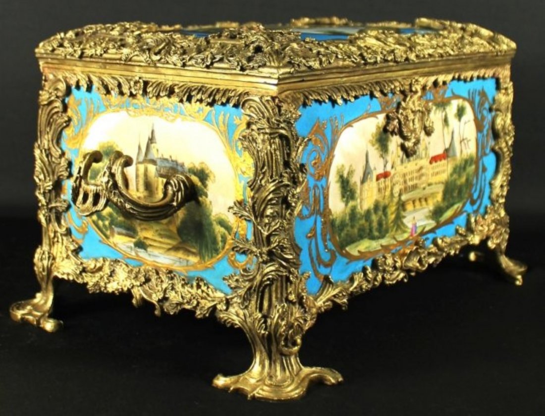 Sevres Bronze Porcelain Casket: Sevres Bronze Porcelain Casket. Measures H: 7 3/4" W: 16"X9", Gorgeous French Sevres style porcelain jewellery box with ormolu fixtures and Elegant panels feature intricate hand painted floral display