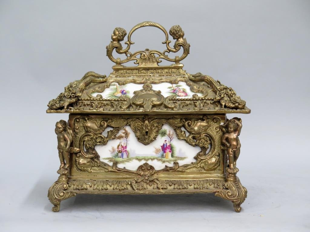 Heavy Sevres Style Porcelain Lady's Box: Putti flanking handles and as decorative posts on all corners. Upholstered interior. Minor oxidation. 14.5W X 10.5"D X 15"H (to finial)."