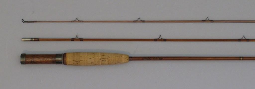Impregnated Cane Rod Marked Dr. Jim Marcks - 6 1/2': 2/2, 2.5oz. The rod has brown guide wraps with black tipping and blued ferrules, a small cigar grip with wood spacer, slide band and cap seat. The rod is marked with name Dr. James Marcks, he was a de