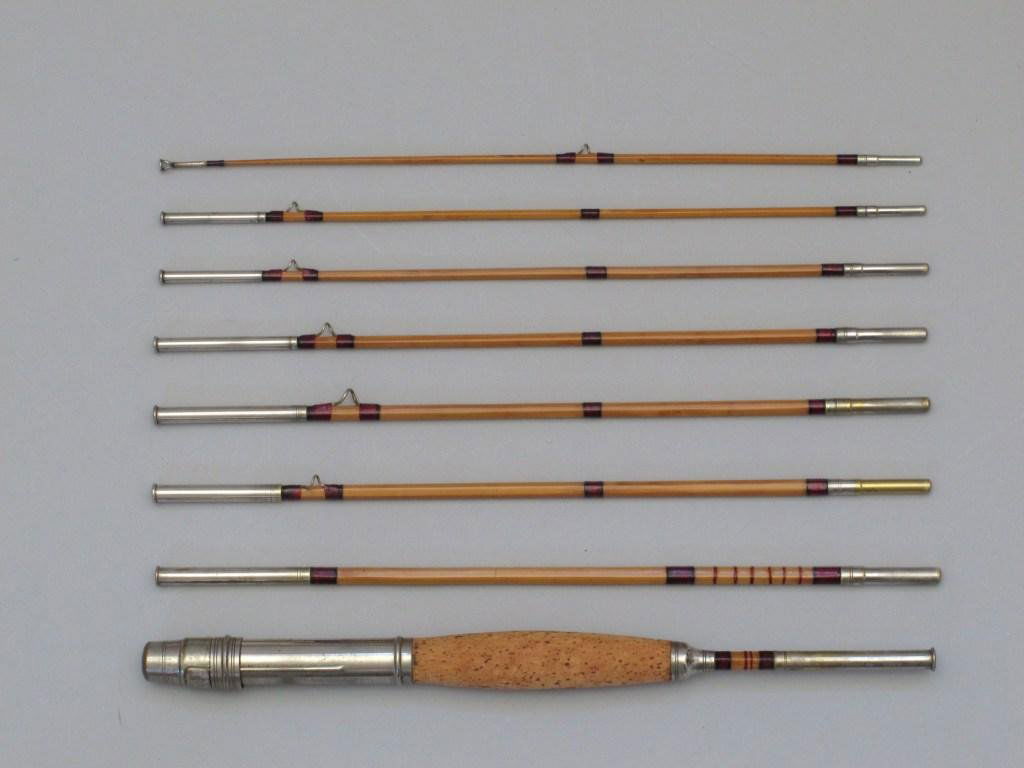 Early 8' Cane Smuggler Rod - 8/1: The rod was refinished at one time and the varnish on the cane is smooth, the wraps are red, tipped in black and not done well, has a small cork grip. The rod will look great in a display case or from