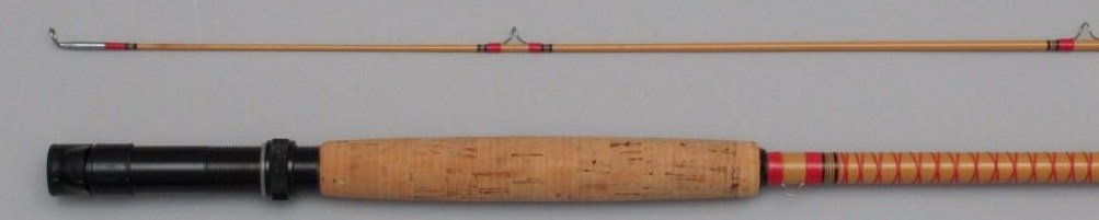 Heddon Mark No.8653 Fiberglass Fly Rod - 8', 8wt, 2/1, : A yellow blank with red wraps tipped in black, a mid-1960's series of glass sleeve ferruled Heddon rods with the sleeve on the rod butt section. The rod is in Excellent condition and comes with an adj