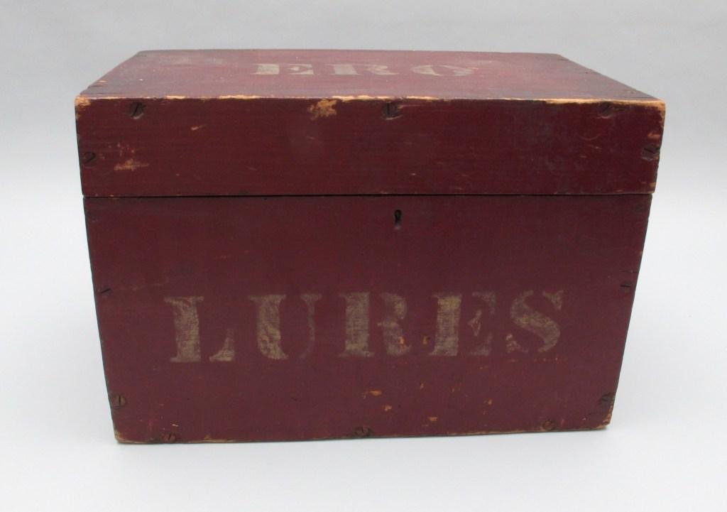 Wood Box in Original Red Paint From Lake Chautauqua, NY: Used to carry fish decoys and when originally found by the consignor in the 1960's contained a nice selection of seymour fish. Finished in old barn red paint, this 9" x 15" x 10" high box has "Lures" 