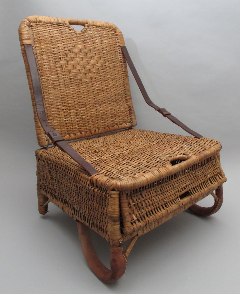 Folding Wicker Canoe Seat: sporting heavy leather straps, storage compartment under the seat and protective leather wrapped legs. This seat is in Excellent condition.