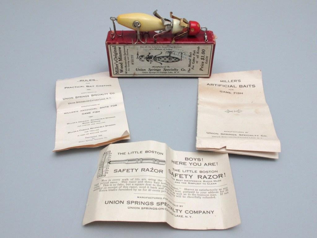 Miller's Reversible Wood Minnow in Orig. Box w/Papers: The lure is most likely in unfished condition as it shows virtually no wear. Finished in white with gold spotted red head, the gold and silver spinners are pristine and the bait comes with neverfail h