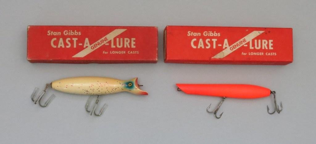Two Stan Gibbs Lures in Correct Boxes: A white 6" GS-3 casting swimmer in Excellent condition. A 6" 1 1/2 or 2 oz. pencil popper in a scarce fluorescent orange finish also in Excellent condition.