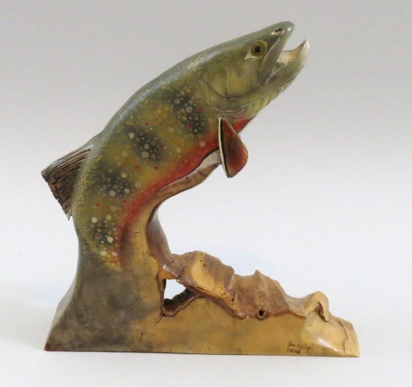 Large Driftwood Carving of a Brook Trout by Jim Wiley: Measuring 11 1/2" x 12 1/4" of a leaping brook trout breaking water. Signed by the carver with his code "0506", carved in 2005 and the sixth carving of that year. This contemporary carver's style is b