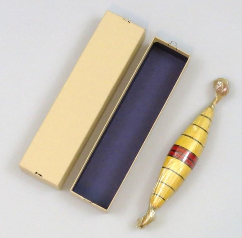 9" Ideal Bobber in Original Cellophane Wrap: Coming in White/Black/Red striped pattern from the Ideal Factory and still wrapped in the original cellophane and in an unlabeled box. Although new and unused there appears to be some heat damage to t