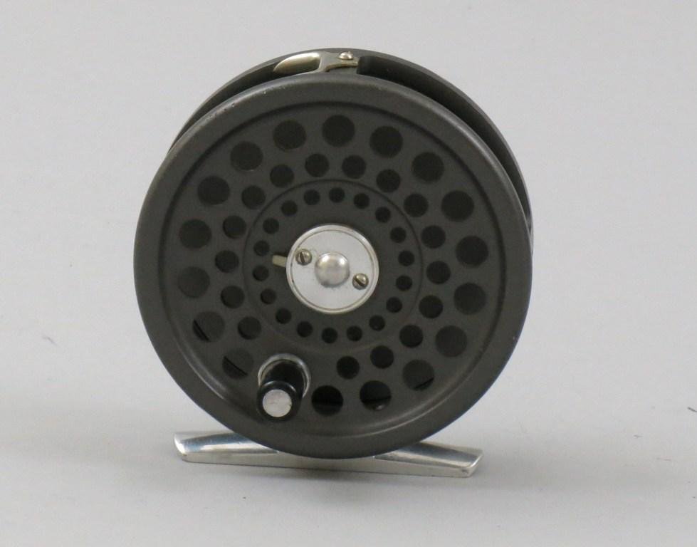 Hardy Marquis 5: A 3" dia. and 11/16" spool width English classic, dark anodizing with an aluminum foot, dual pawl click drag for LHW or RHW. Reel has some rim rash, Very Good condition.