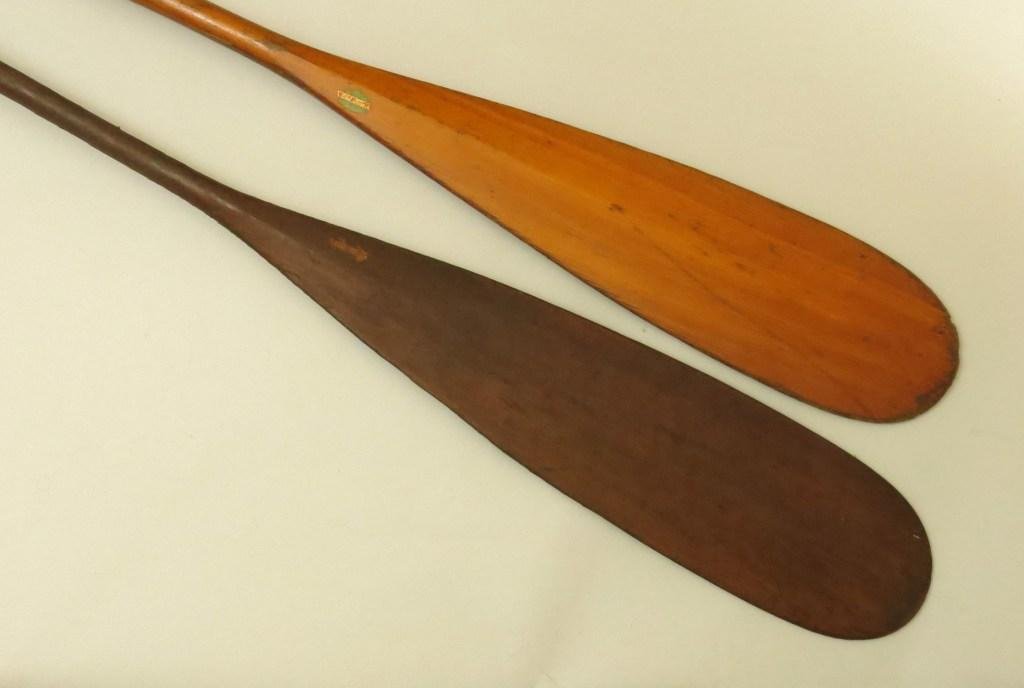 Pair of Old Town Canoe Paddles: Measuring 63" and 66" long and tan and walnut colored respectively. The Old Town Canoe decal is retained on each one, 85% and 50% respectively. Both in Very Good condition.