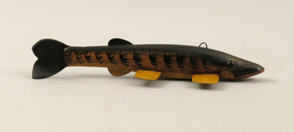 C.B. (Bruce) Lewis Musky Decoy: This Chautauqua style, spade-head musky decoy measures 8 1/2" and the minimal paint effects help bring this fish to life. Epoxy impregnated vintage leather tale. Carver's signature stamp mark on front