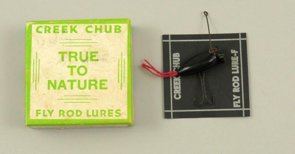 Creek Chub Fly Rod Bug Wiggler in Box: Bait has heavily corroded hardware, body is most likely repainted and tail is most likely a replacement. Card and box are clean and unmarked. Good example of a hard to find bait and box combination.