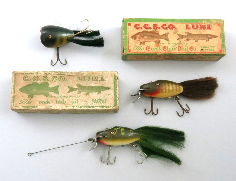 Group of Three Creek Chub Hair Baits: Includes an Excellent minus frog spot Dinger with light surface scrapes, good hair, perfect eyes, clean hardware, stenciled back. Also includes a Good plus Pikie scale Dinger, good eyes, stenciled bac