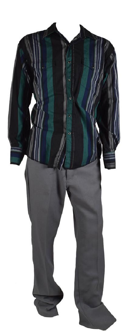 Benicio Del Toro Screen-Worn Outfit from Traffic: Outfit comprised of a long-sleeve button-up shirt and gray pants, both made by Wrangler, worn on screen by Benicio del Toro in his acclaimed role as Javier Rodriguez in the 2000 crime drama Traffic. T