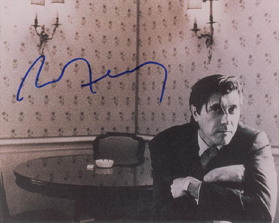 Roxy Music: Bryan Ferry Signed Photograph: Glossy 10 x 8 half-length photo of the Roxy Music singer with his arms folded over the back of a chair, signed in blue felt tip by Bryan Ferry. In fine condition.