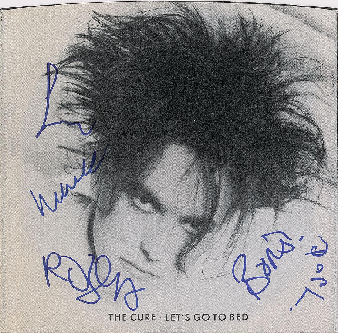 The Cure Signed 45 RPM Record: 45 RPM single record for 'Let's Go To Bed / Boys Don't Cry,' signed on the front of the sleeve in blue felt tip by Robert Smith, Lol Tolhurst, Porl Thompson, Boris Williams, and one other. In fine con