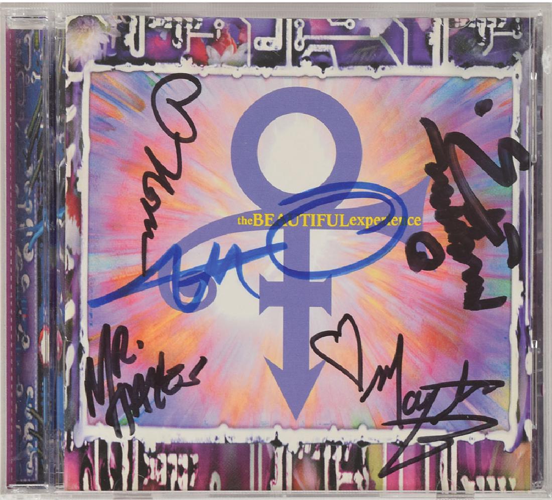 Prince Signed CD: The Beautiful Experience CD signed on the front of the booklet in blue felt tip by Prince, who uses his 'love symbol.' Also signed on the front of the booklet in black felt tip by Mayte Garcia, Mr. Ha
