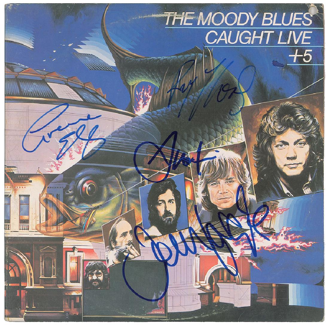 The Moody Blues Signed Album: Caught Live + 5 album signed on the front cover in blue felt tip by Graeme Edge, Ray Thomas, John Lodge, and Justin Hayward. In fine condition, with light scuffing (and one small area colored in), and