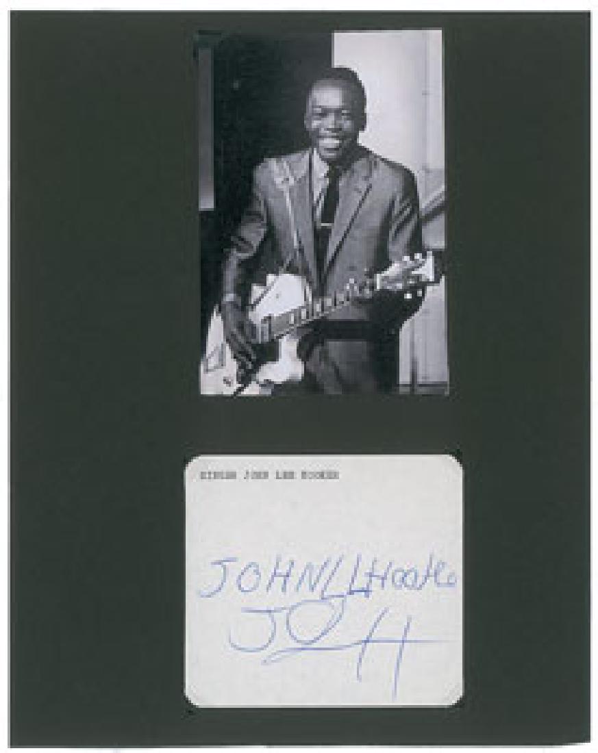 John Lee Hooker Signature: Vintage ballpoint signature, "John L. Hooker, JLH,” on an off-white 4 x 3.5 sheet. Removably corner-mounted to a display sheet with an image of Hooker. In fine condition. Format: Signature