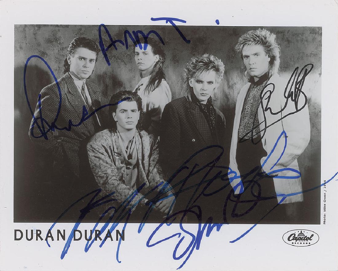 Duran Duran: Glossy 10 x 8 Capitol Records publicity photo of Duran Duran from 1984, signed in felt tip by Simon Le Bon, Nick Rhodes, Roger Taylor, John Taylor, and Andy Taylor. In fine condition. Format: Signed P