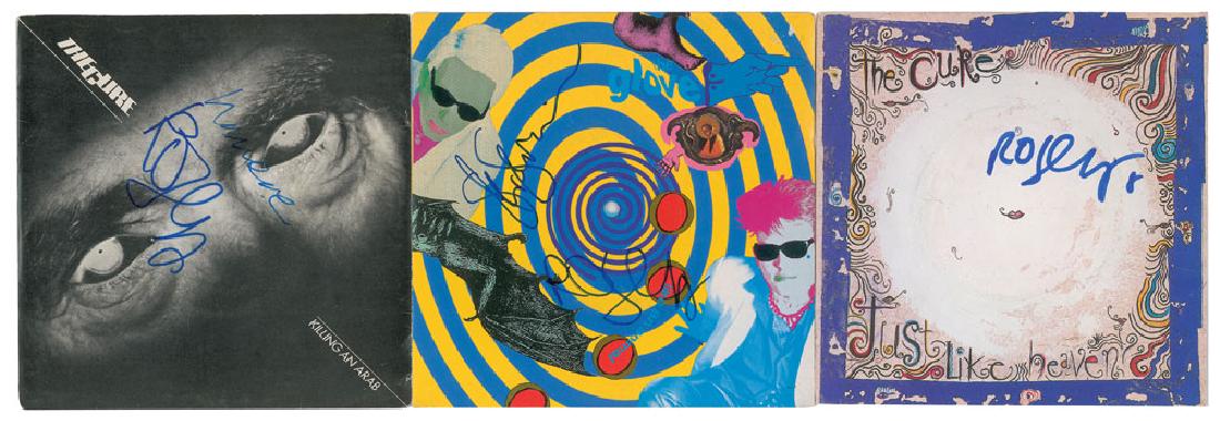 The Cure: Three 45 RPM single records: 'Like an Animal / Mouth to Mouth' by The Glove, signed on the front cover in blue felt tip by Robert Smith and Steven Severin; 'Killing an Arab / 10:15 Saturday Night' by