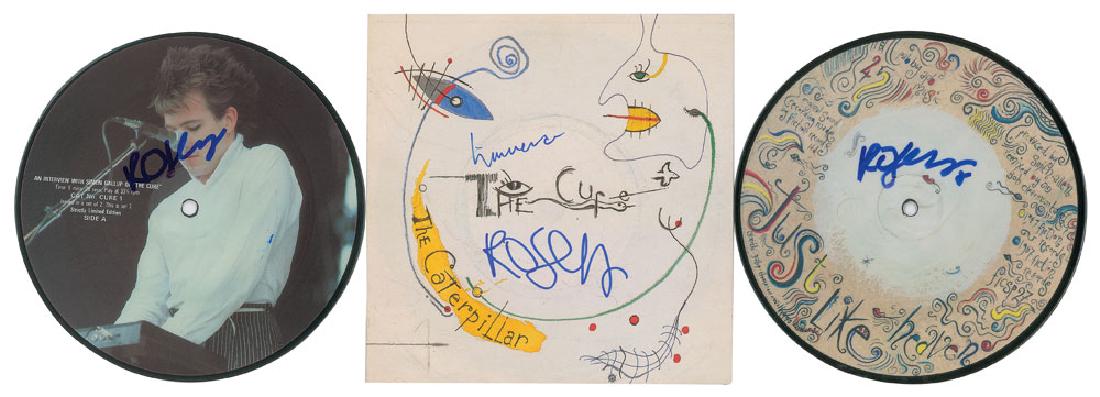 The Cure: Robert Smith: Three 45 RPM records signed in blue felt tip by Robert Smith: a limited edition picture disc for 'An Interview with Simon Gallup of the Cure"; a picture disc for the single 'Just like Heaven / Snow in