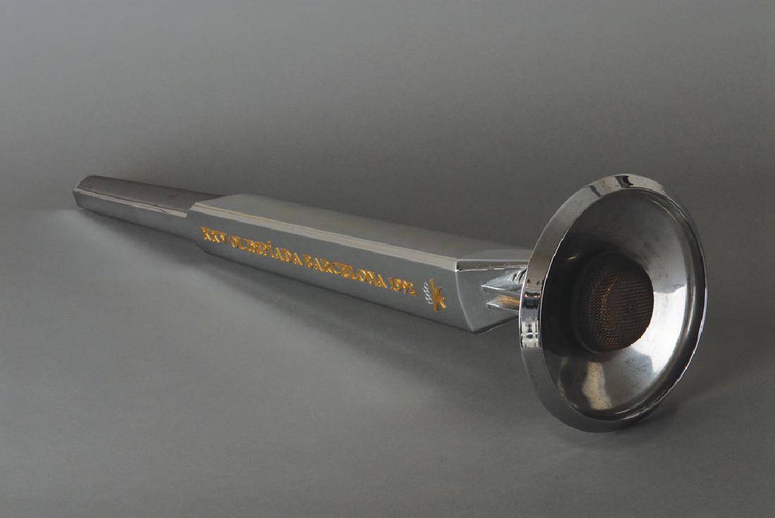 Barcelona 1992 Summer Olympics Torch: Official 1992 Barcelona Olympics torch, comprised of aluminum and plastic, measuring 26Ë in length and 7Ë at its widest point, designed by Andre Ricard. The metal body is inscribed in gold text, "XX