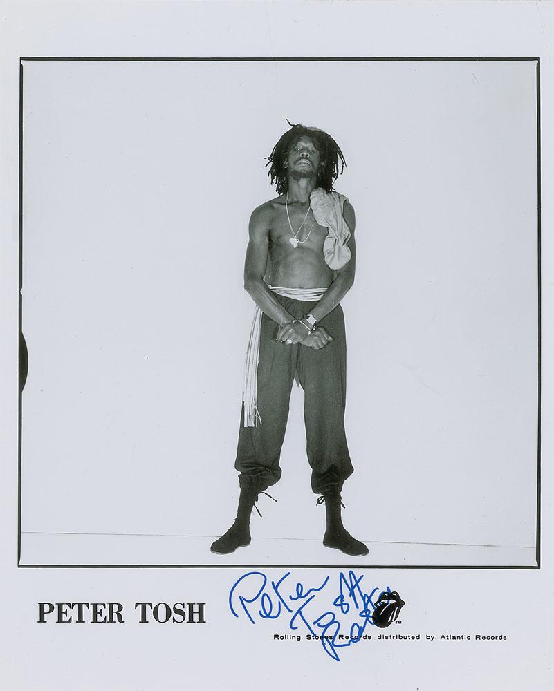 Peter Tosh: Glossy 8 x 10 Rolling Stones Records publicity photo of the reggae star, signed in blue felt tip, "Peter Tosh, Rasta." In fine condition, with a crease to the upper right corner tip. Format: Signed Ph