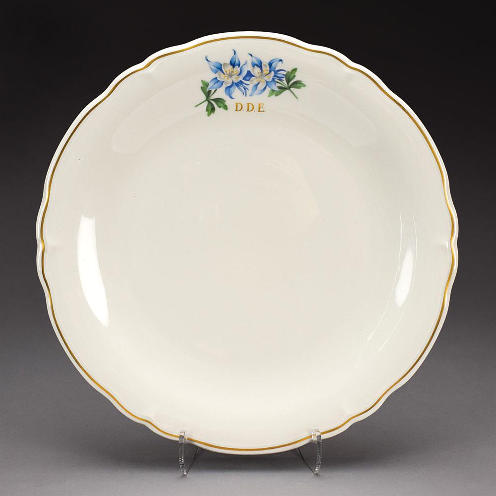 Dwight D. Eisenhower Air Force One Presidential China: Official china plate from President Dwight D. Eisenhower's Air Force One. The white dinner plate measures 10? in diameter, and features a blue-and-white flower design at the top, his gilt initials "D.