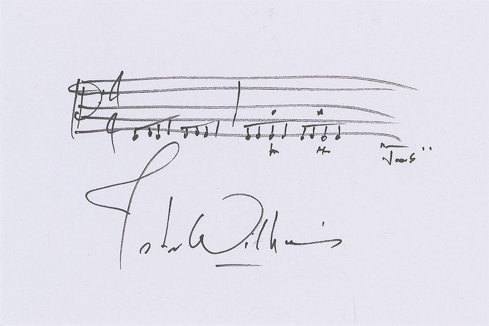 John Williams: Two items: an AMQS featuring two bars of his iconic theme from Jaws on a white 6 x 4 card, signed in black felt tip by Williams; and a felt tip signature, "John Williams," on a white 5 x 3 card. In ve