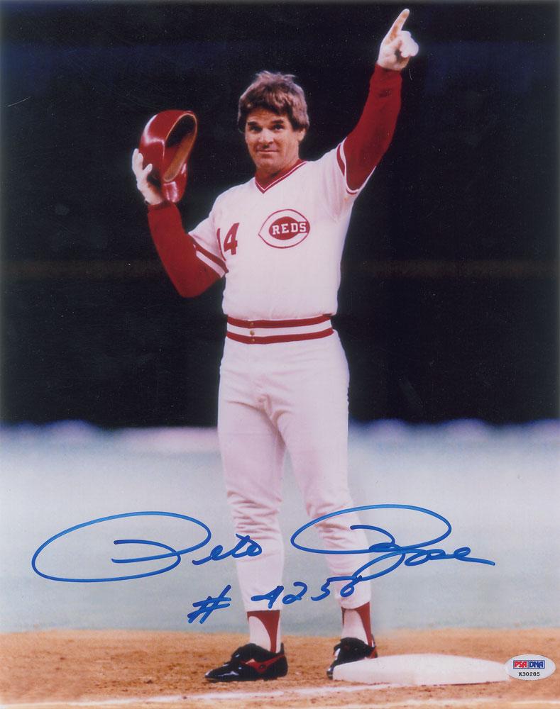 Pete Rose Signed Photograph: Color glossy 11 x 14 full-length photo of Pete Rose pointing to the stands after smacking his record-breaking 4,192nd career hit on September 11, 1985, signed in blue felt tip, "Pete Rose, #4256." In