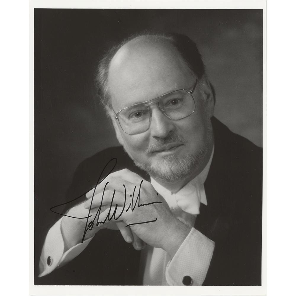 John Williams Signed Photograph: Glossy 8 x 10 photo of John Williams in formal attire, signed in black felt tip by the great composer. In fine condition, with a few small creases.
