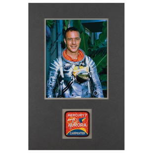 Scott Carpenter Signed Photograph: Color satin-finish 8 x 10 photo of Carpenter in his silver Mercury suit, signed in black felt tip, "Scott Carpenter, Aurora 7." Nicely double-matted above an embroidered Aurora 7 mission patch to an