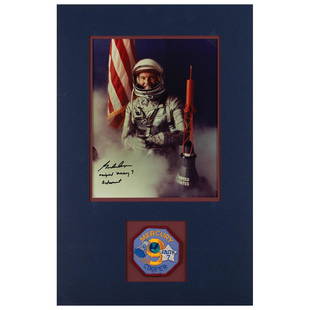 Gordon Cooper Signed Photograph: Color satin-finish 8 x 10 photo of Cooper posing in his silver Mercury suit beside a spacecraft model and the American flag, signed in black felt tip, "Gordon Cooper, original Mercury 7 Astronaut."