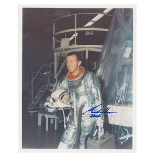 Gordon Cooper Signed Photograph: Color satin-finish 8 x 10 photo of Cooper wearing his silver space suit during the Mercury program, signed in blue felt tip, "Gordon Cooper, Faith 7." In fine condition, with a light bend near the