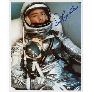 Scott Carpenter Signed Photograph: Color satin-finish 8 x 10 photo of the Mercury-Atlas 7 pilot seated in his space suit, signed in blue felt tip by Scott Carpenter. In fine condition.