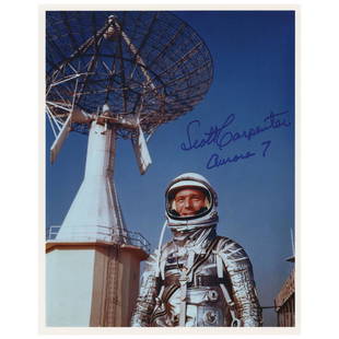 Scott Carpenter Signed Photograph: Color satin-finish 8 x 10 photo of Carpenter posing in his silver Project Mercury suit, signed in blue felt tip, "Scott Carpenter, Aurora 7." In very fine condition.