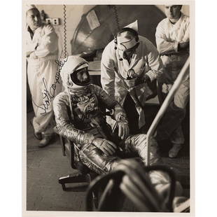 Scott Carpenter Signed Photograph: Official glossy 8 x 10 NASA photo of Scott Carpenter seated in his Mercury suit, signed in black felt tip. Reverse bears a NASA and U.S. Air Force stamp and text dated to December 20, 1961. In fine