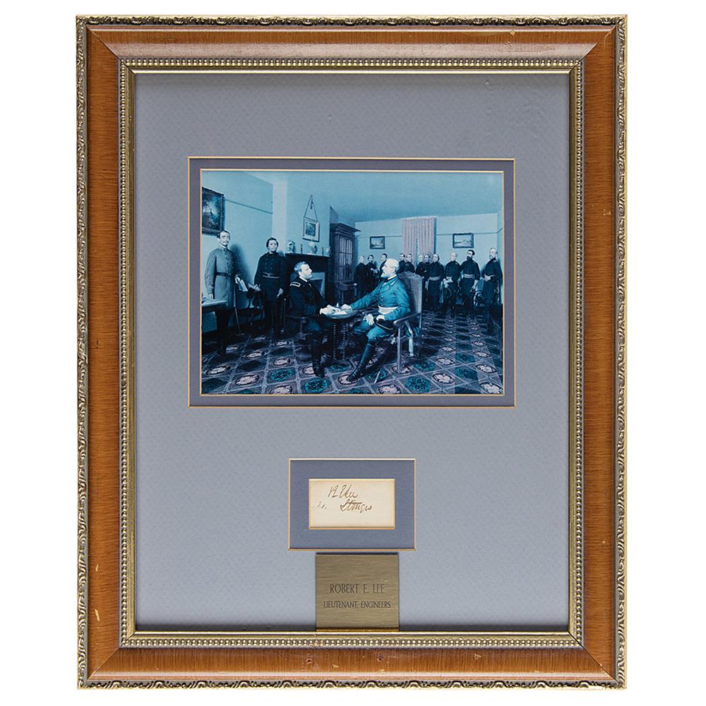 Robert E. Lee Signature: Ink signature, "R. E. Lee, Lt. Engrs.," on an off-white 2 x 1.25 slip. Double-matted and framed with a photo and plaque to an overall size of 13.5 x 16.5. In fine condition, with a slightly clipped up