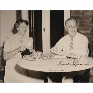 Franklin and Eleanor Roosevelt Signed 1941 Christmas Photograph as President and First Lady: Rare and charming matte-finish 9.5 x 7.5 photo of Franklin and Eleanor Roosevelt relaxing at a patio table with a book and some knitting, an image originally taken on the south porch at Hyde Park on J