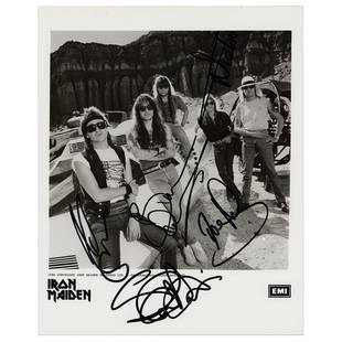 Iron Maiden Signed Photograph: Glossy 8 x 10 EMI promo photo of Iron Maiden, signed in black felt tip by Bruce Dickinson, Dave Murray, Nicko McBrain, Steve Harris, and Adrian Smith. In fine condition.