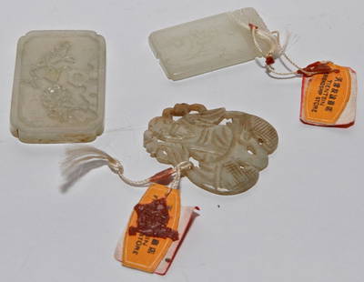 Three Jade Pendants: Early 20th century white jade plaques. Two with original Hong Kong antique store tags still attached. Measurements: 4.2x2.1cm (large rectangular), 3.5x2cm (small rectangular), 3.6x3.1cm (irregular