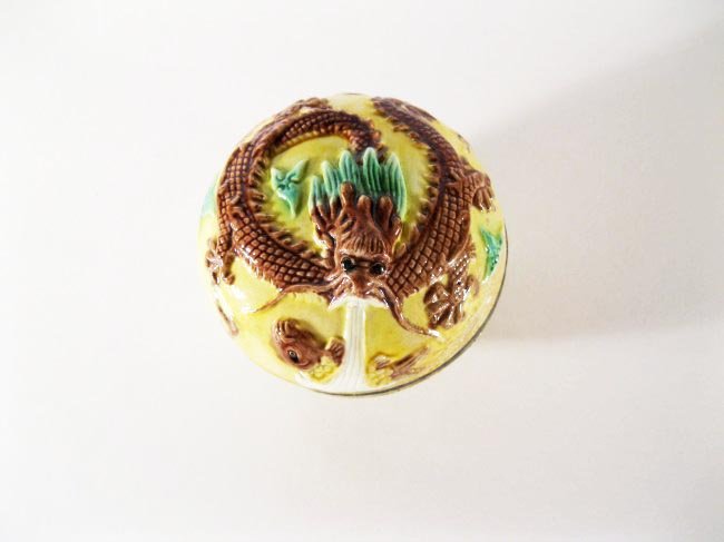 Antique Porcelain Box, Qianlong Mark: Antique Porcelain Box, Qianlong Mark on base. A yellow ground porcelain enameled box with a dragon design and supported on an unglazed foot rim. Height: 3 inches (7.6cm). Diameter: 3.3 inches (8.5cm).
