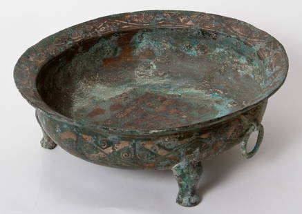 Bronze Tripod Ritual Vessel, China, Warring States: A Bronze Tripod Ritual Vessel, Warring States Period (475-221 BC). Raised on three stout supports, the sides and rim with a band of scrolling motifs, a pair of handles designed as Taotie masks