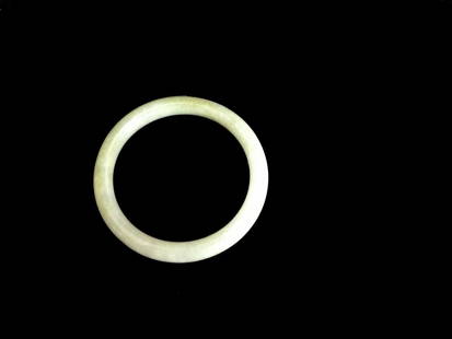 Green Jadeite Bangle: Green jadeite bangle. Finely polished and of good translucency. Inner Diameter: 2 inches (5.2 cm)